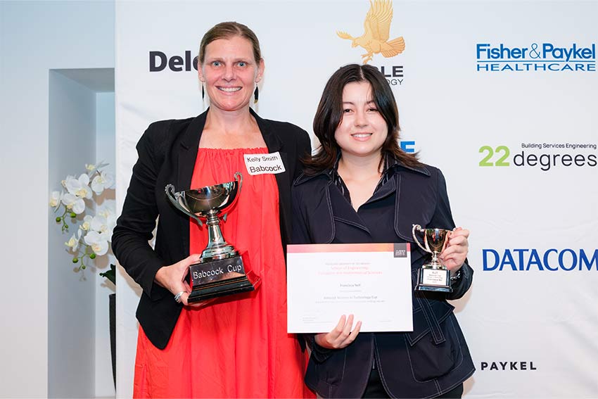 Two women at an awards ceremony are having a photo taken